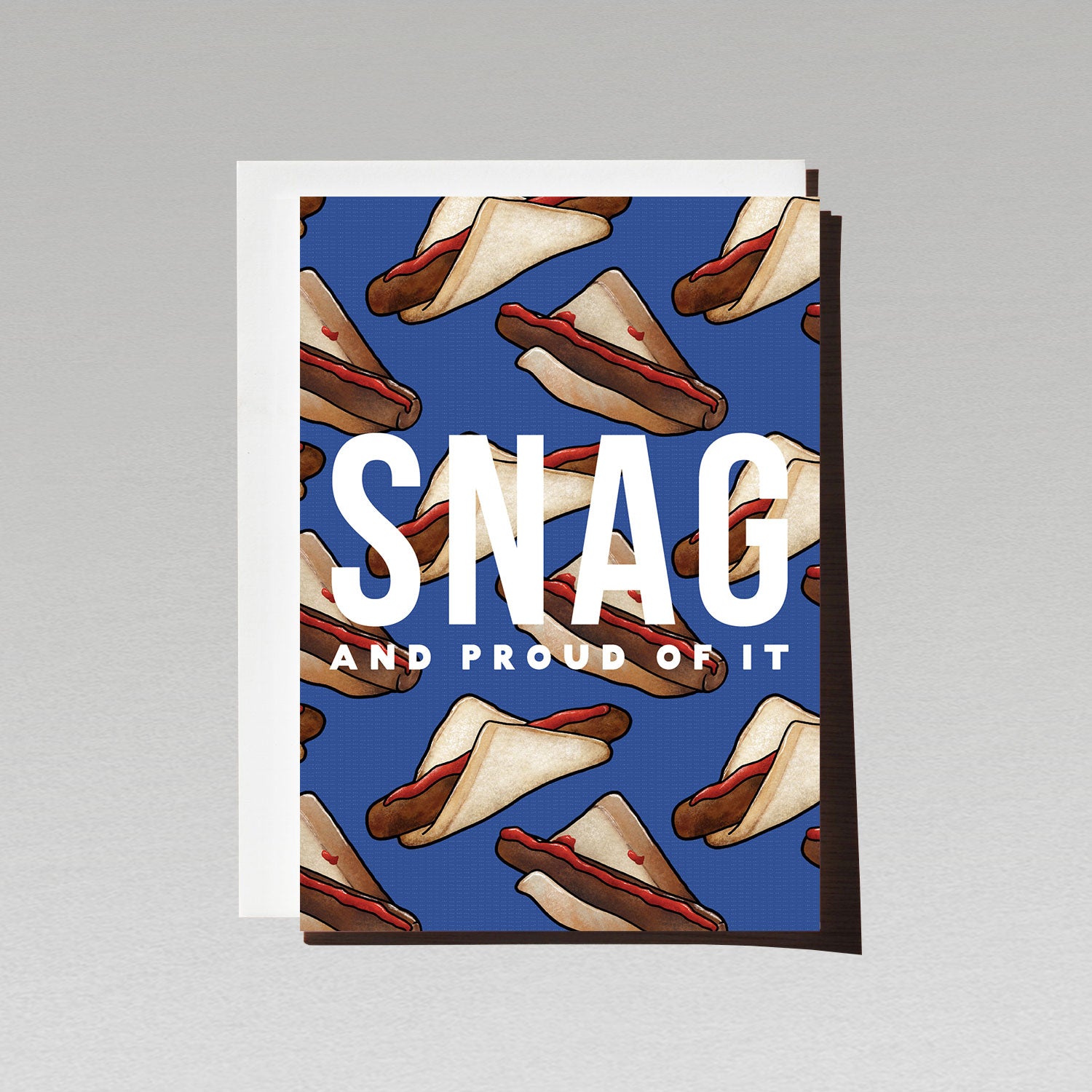 Greeting card with Aussie sausage sizzle sausages in white bread on blue background with text SNAG and proud of it